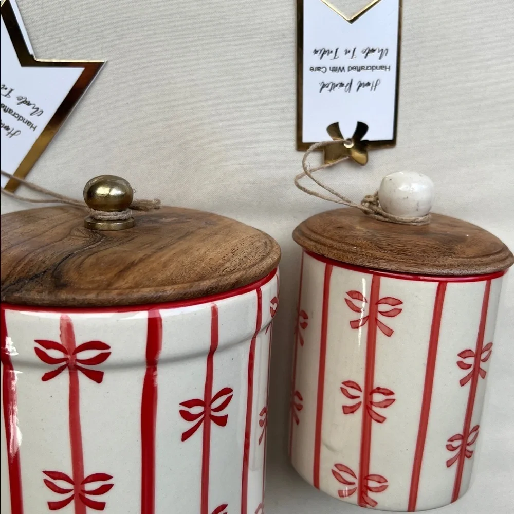 Ceramic holiday canister with red vertical stripes and bows